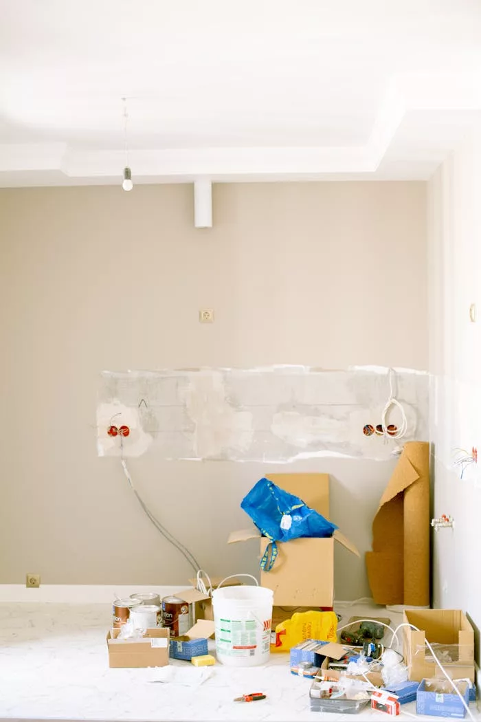 Crafting Captivating Headlines: Your awesome post title goes here An indoor scene showing a messy home renovation project with tools, paint, and materials scattered around.