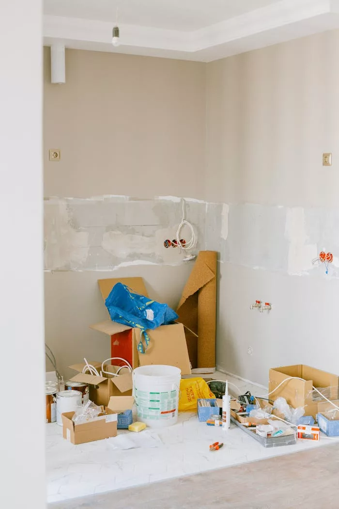 Mastering the First Impression: Your intriguing post title goes here A room in the midst of home renovation with tools and supplies scattered around.