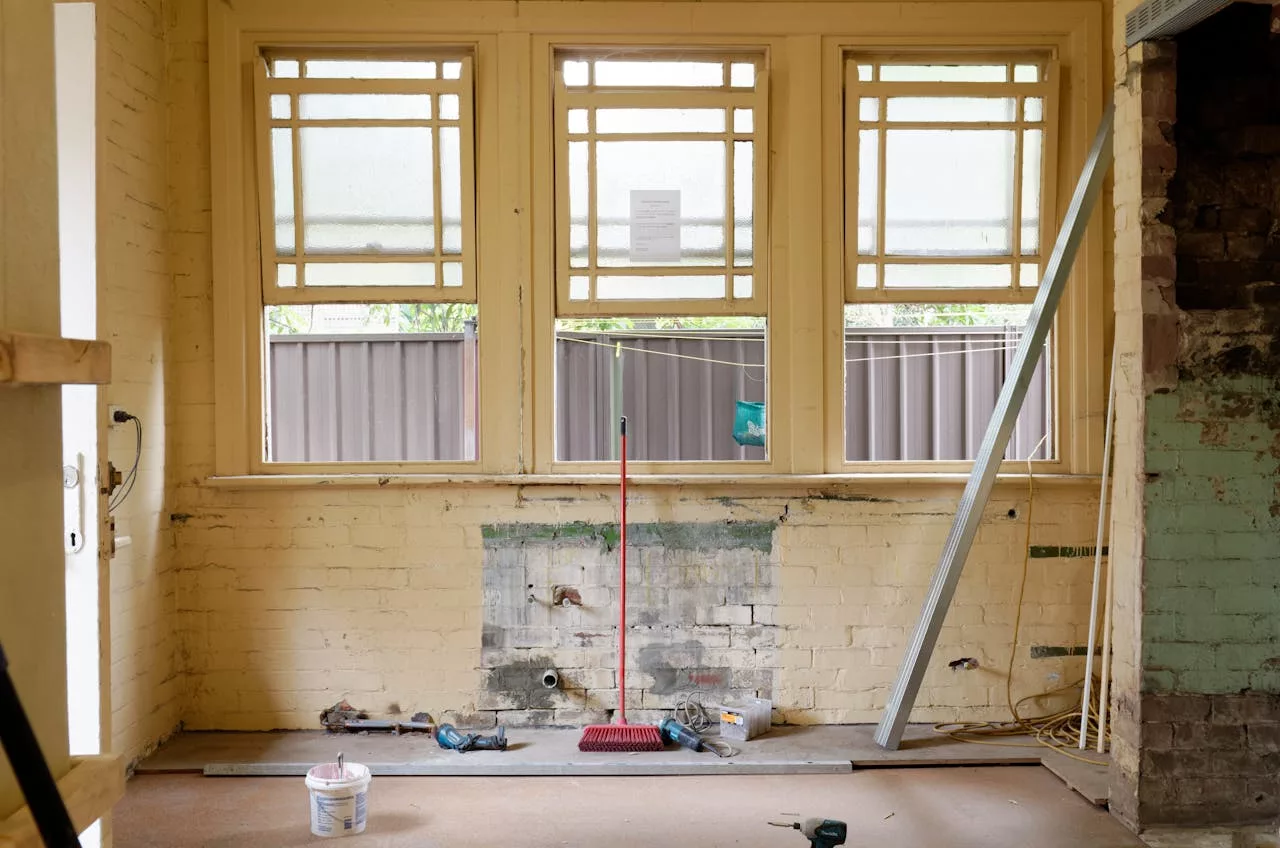 about-us An empty room featuring large windows, ready for renovation in Sydney, Australia.